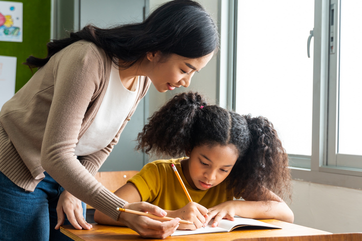 teacher helping student