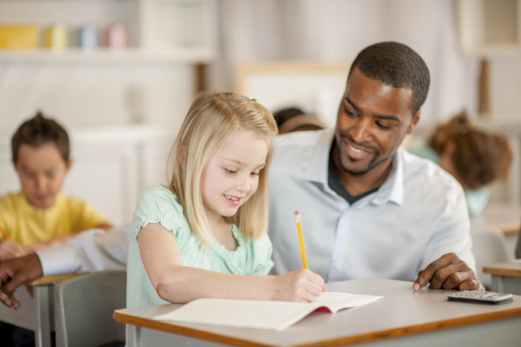 teacher helping student