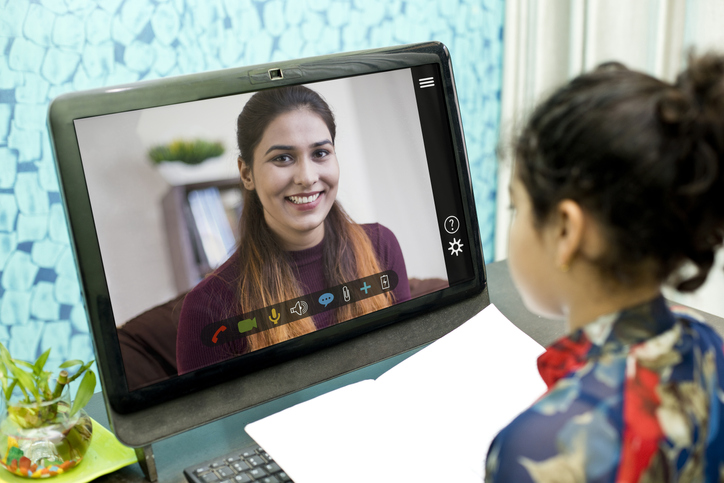 student talking to teacher via video chat