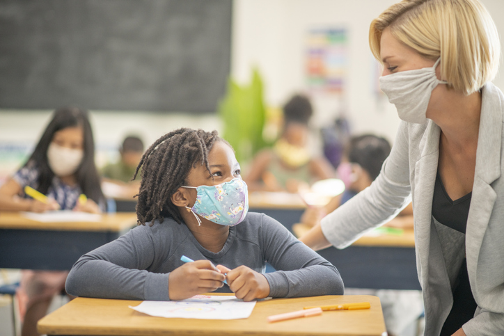 teacher helping student