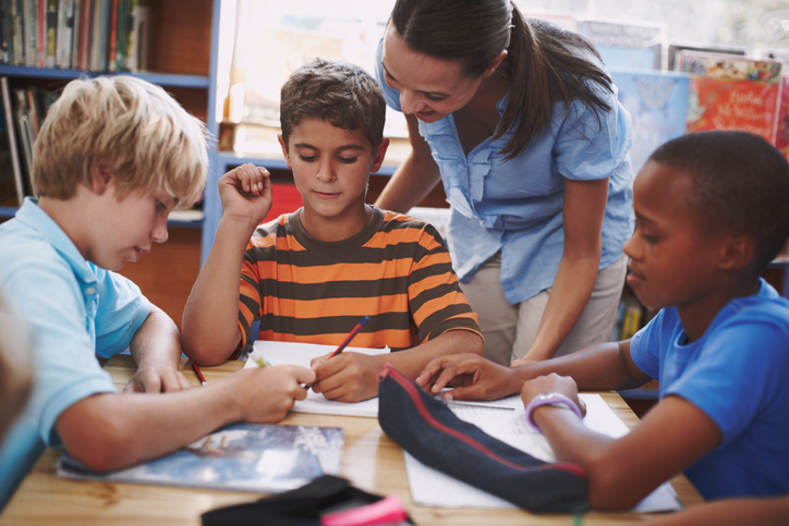 teacher helping students