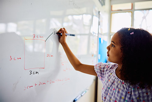 Girl writing on whiteboard