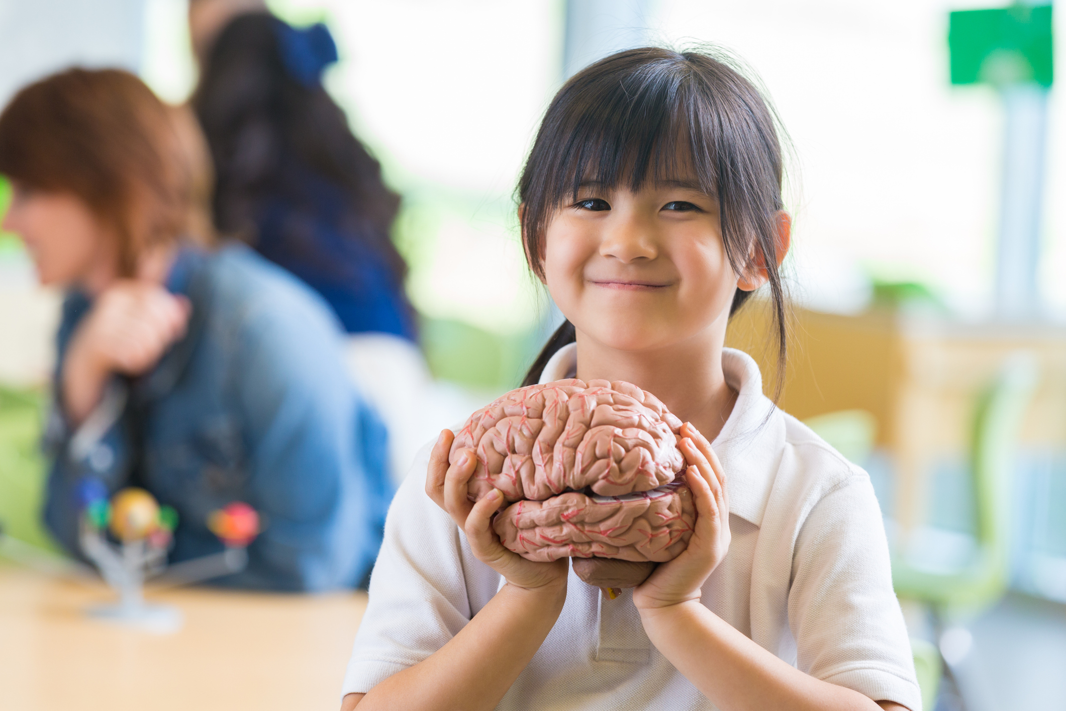 Student Holding Brain