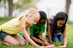 Students using magnifying glass